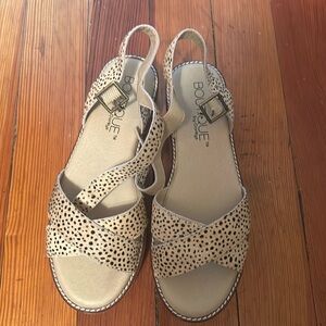 Never been worn platform wedges with leopard pattern on the straps.